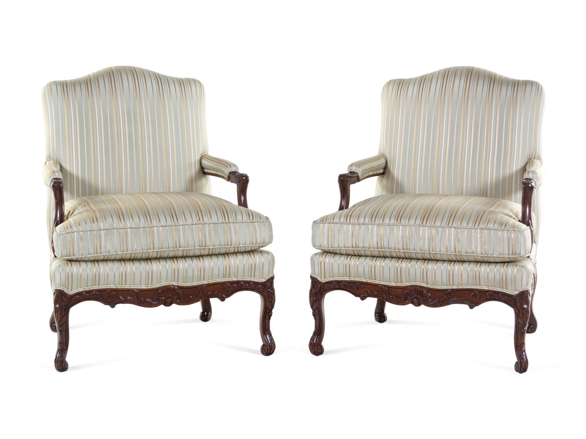 A Pair of Louis XV Style Carved Walnut Fauteuils