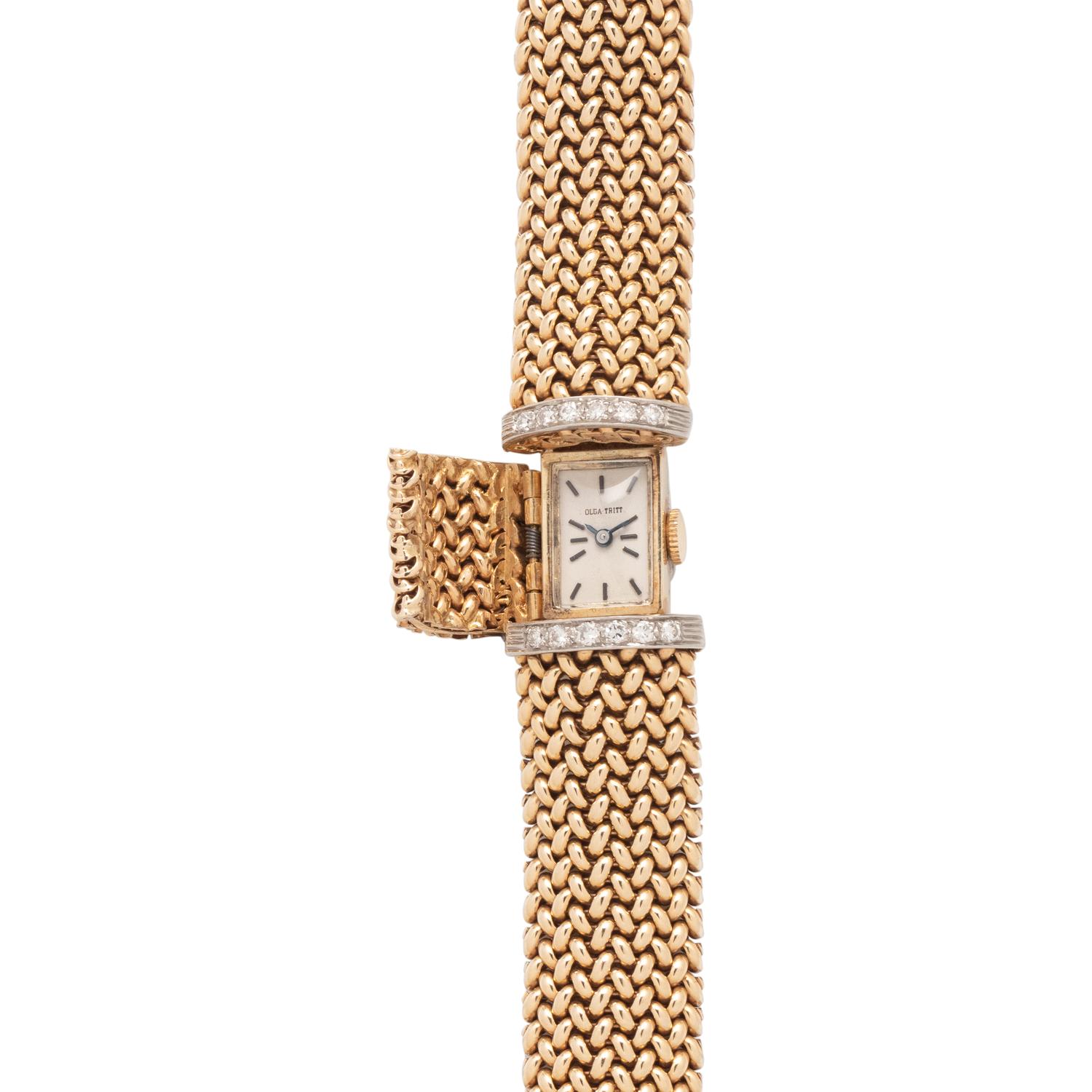 OLGA TRITT, YELLOW GOLD AND DIAMOND SURPRISE WATCH