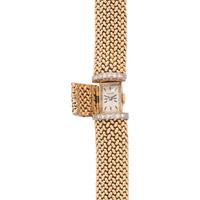 OLGA TRITT, YELLOW GOLD AND DIAMOND SURPRISE WATCH