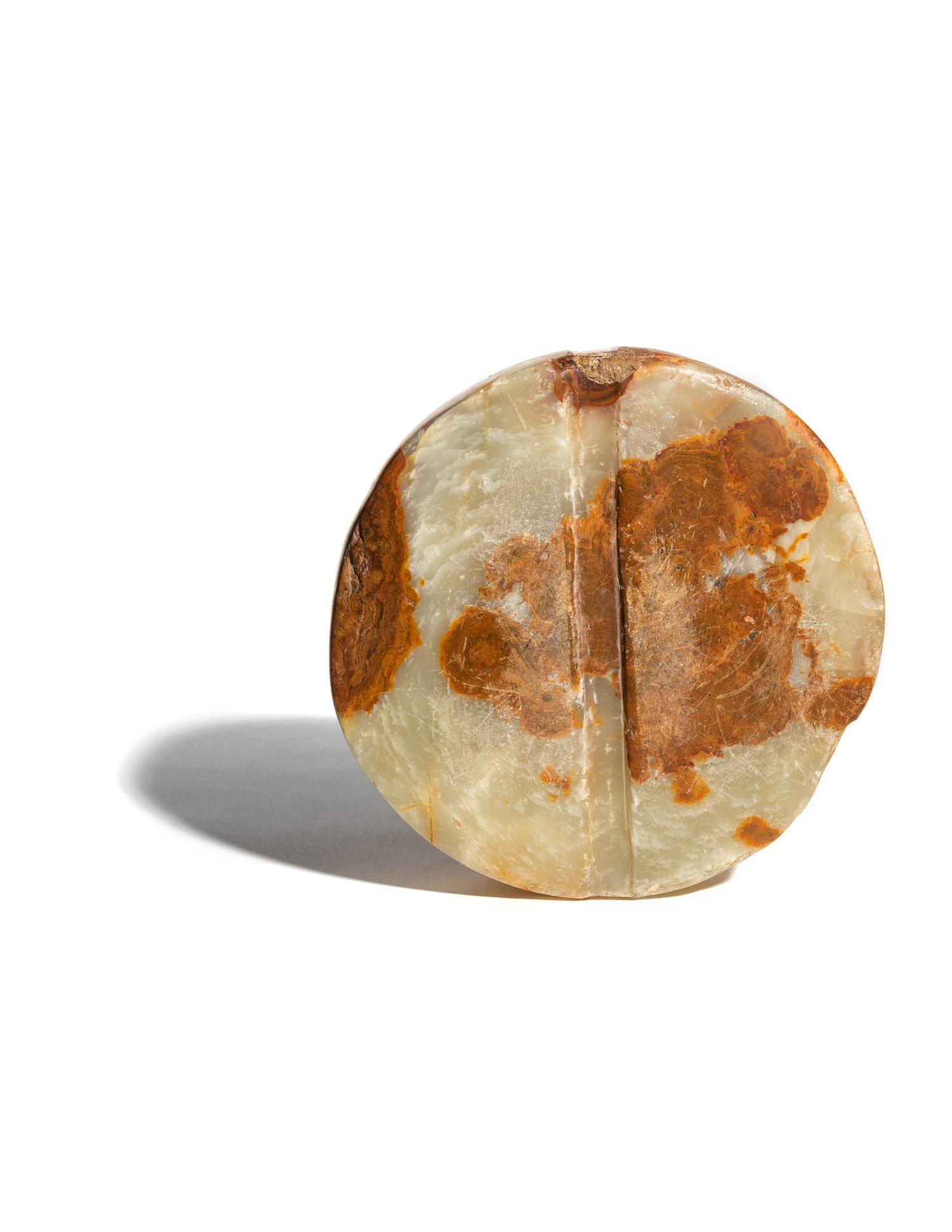 A Bactrian Mottled Green-Orange Stone Disk Ritual Object