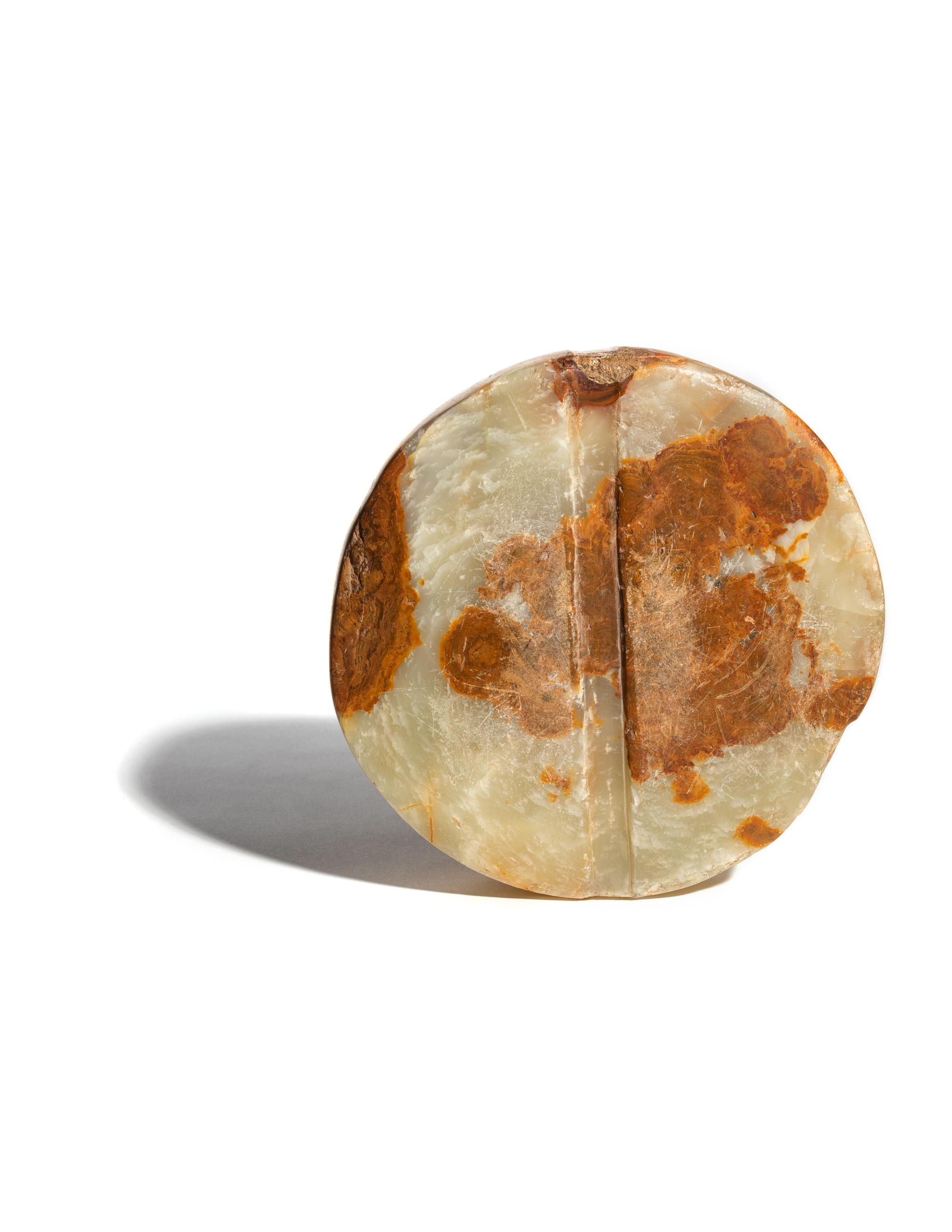 A Bactrian Mottled Green-Orange Stone Disk Ritual Object