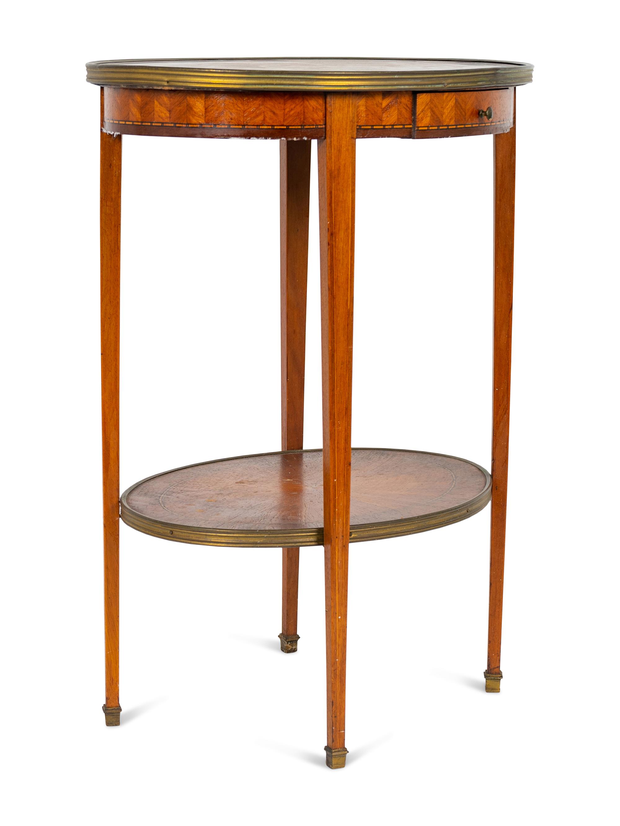A Louis XVI Two-Tier Marble Inset Top Gilt Metal Mounted Oval Marquetry Side Table — 19TH CENTURY