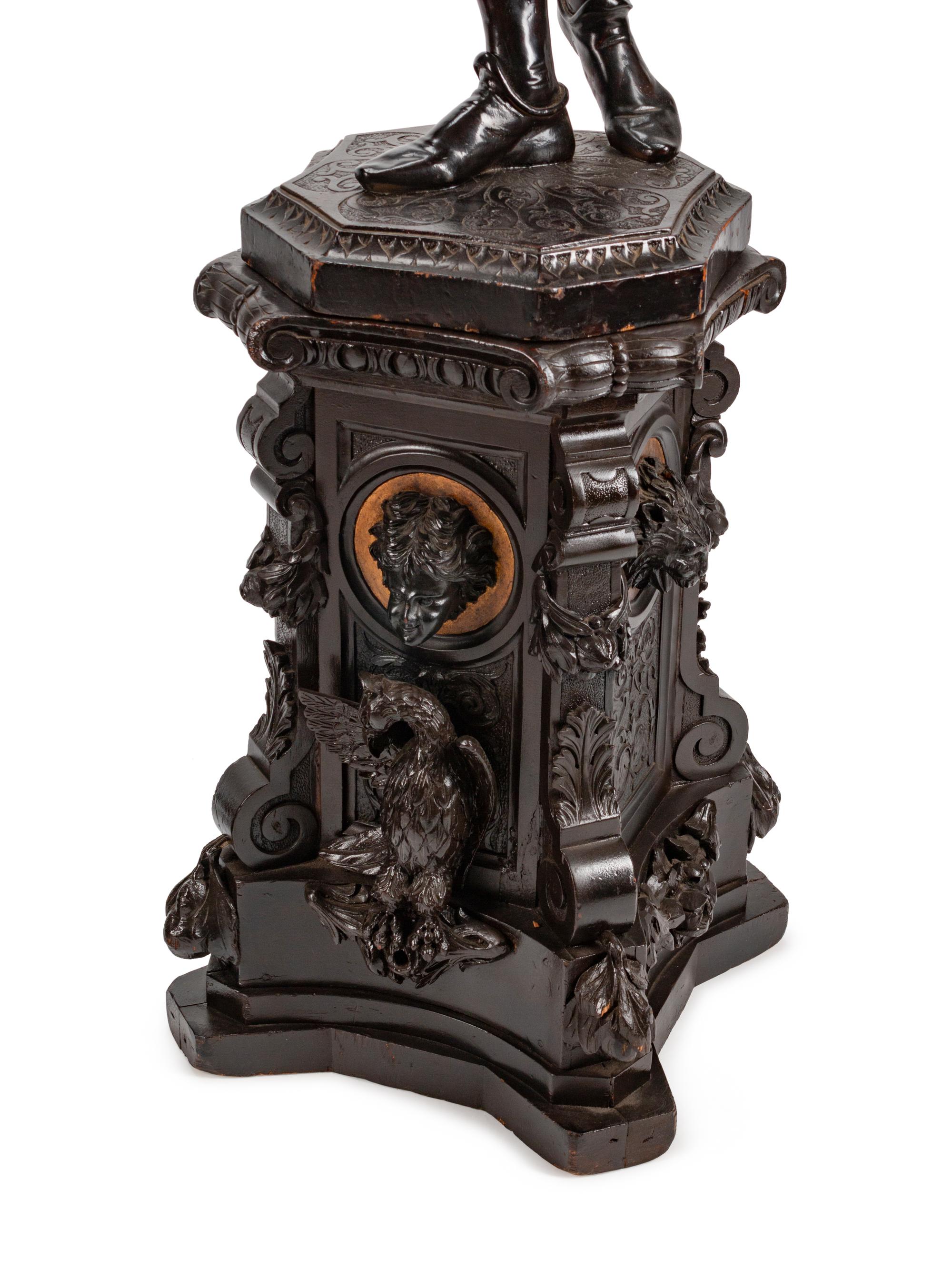 A Large Pair of English Parcel-Gilt and Stained Wood Figural Torchères on Stands