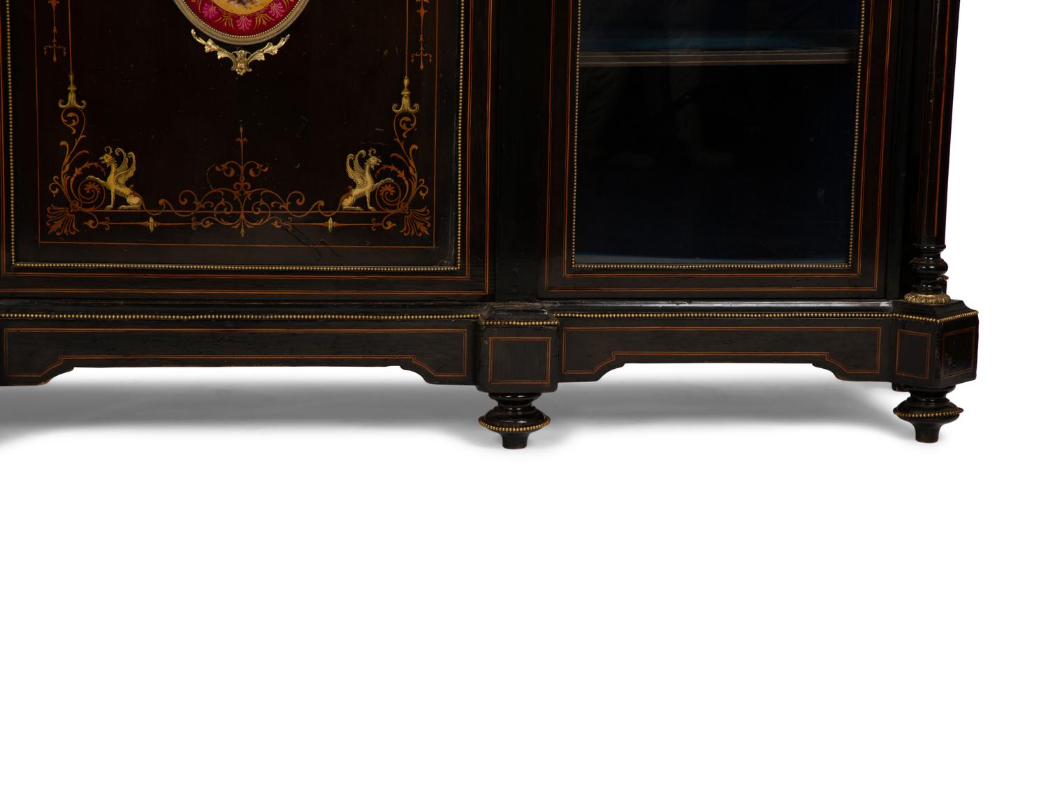 A Napoleon III Gilt Bronze and Porcelain Mounted Ebony and Marquetry Cabinet — CIRCA 1870