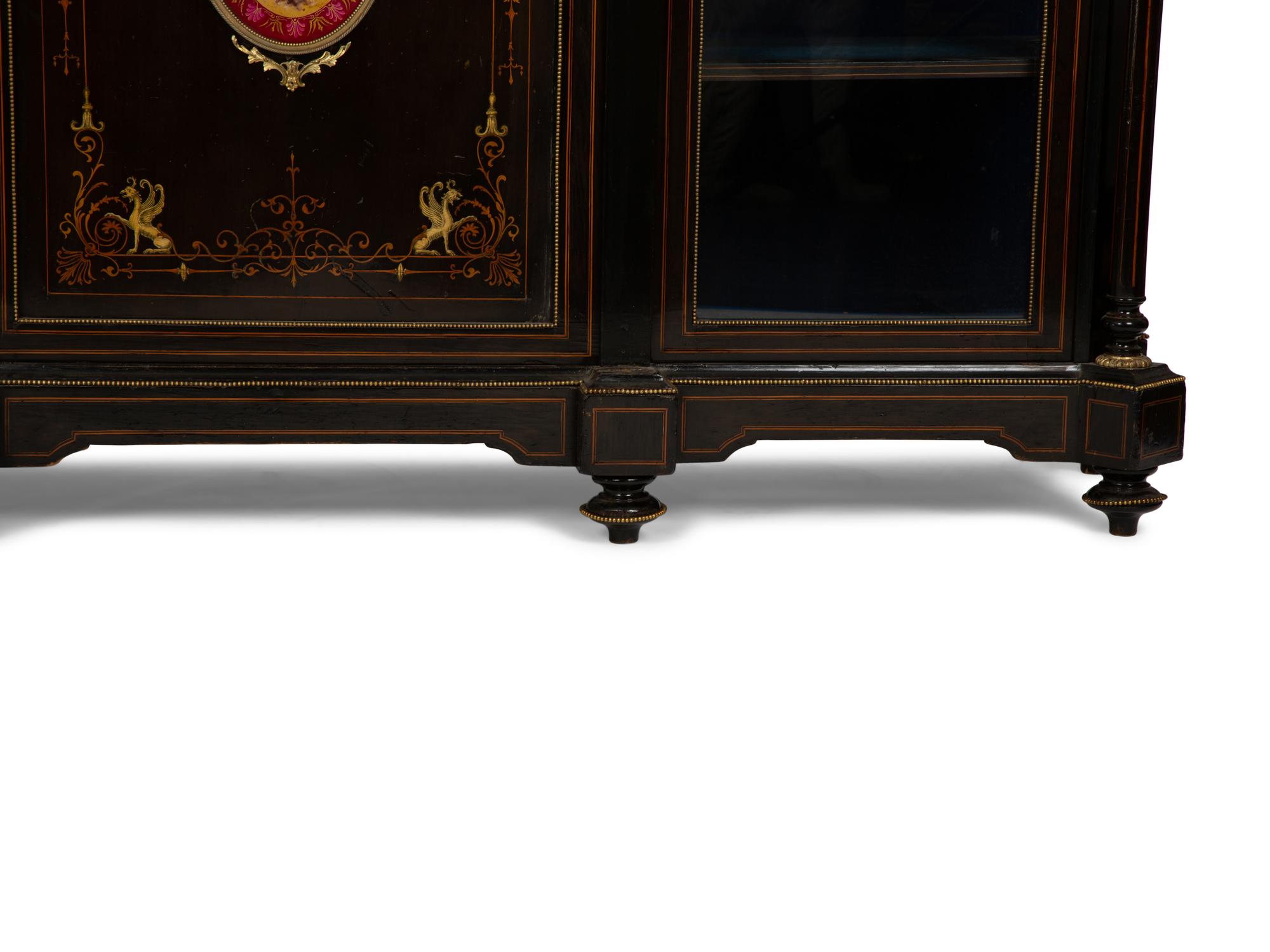 A Napoleon III Gilt Bronze and Porcelain Mounted Ebony and Marquetry Cabinet — CIRCA 1870