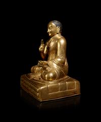 A Large Sino-Tibetan Gilt Copper Repoussé Figure of a Seated Lama