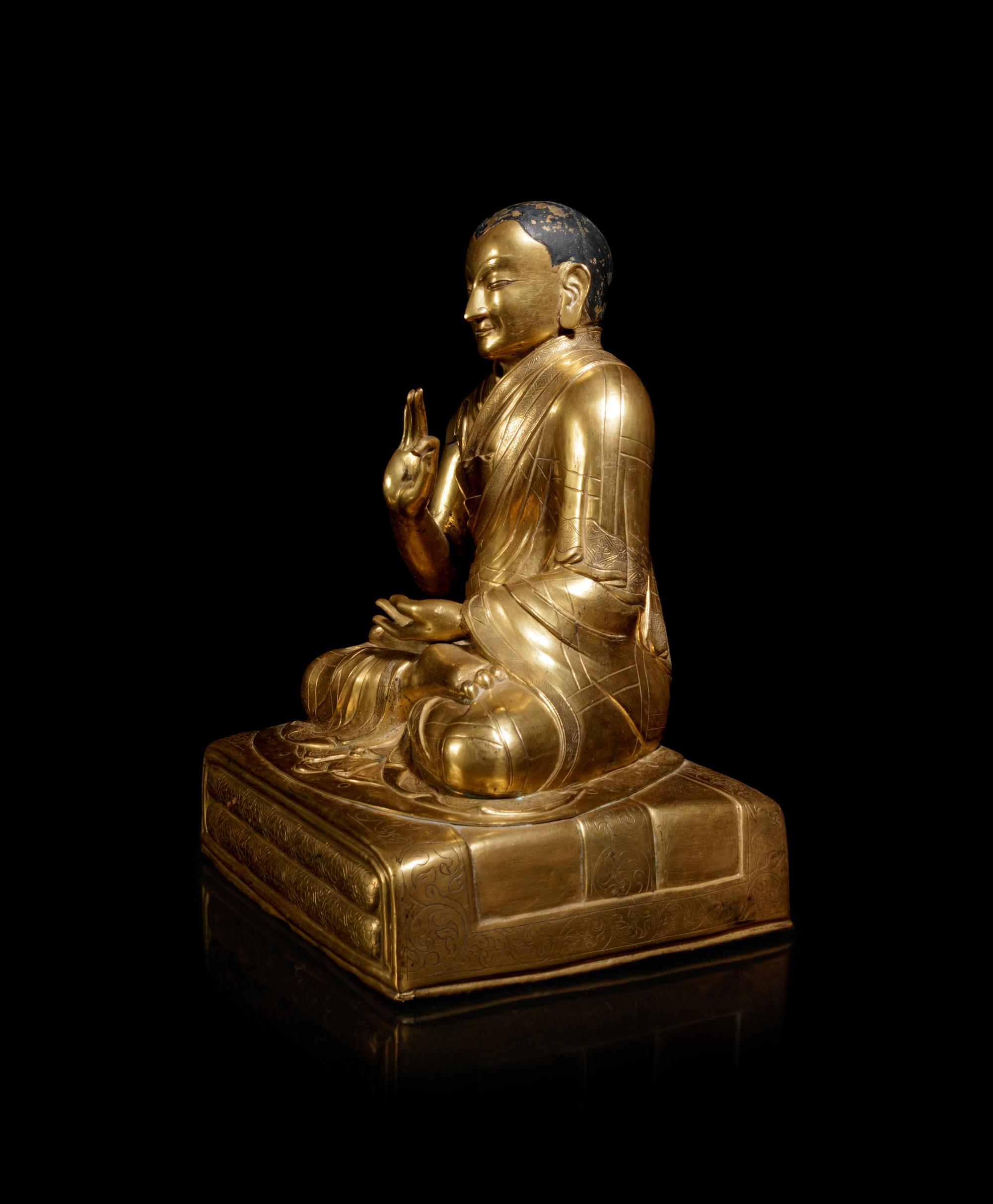 A Large Sino-Tibetan Gilt Copper Repoussé Figure of a Seated Lama