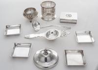 A Collection of Silver-plate Table Articles, , comprising four square nut dishes, a lidded box, a tea strainer, a ladle and others, 10