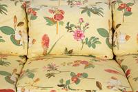 A Yellow Floral Chintz Upholstered Sofa and a Pair of Matching Drapes
