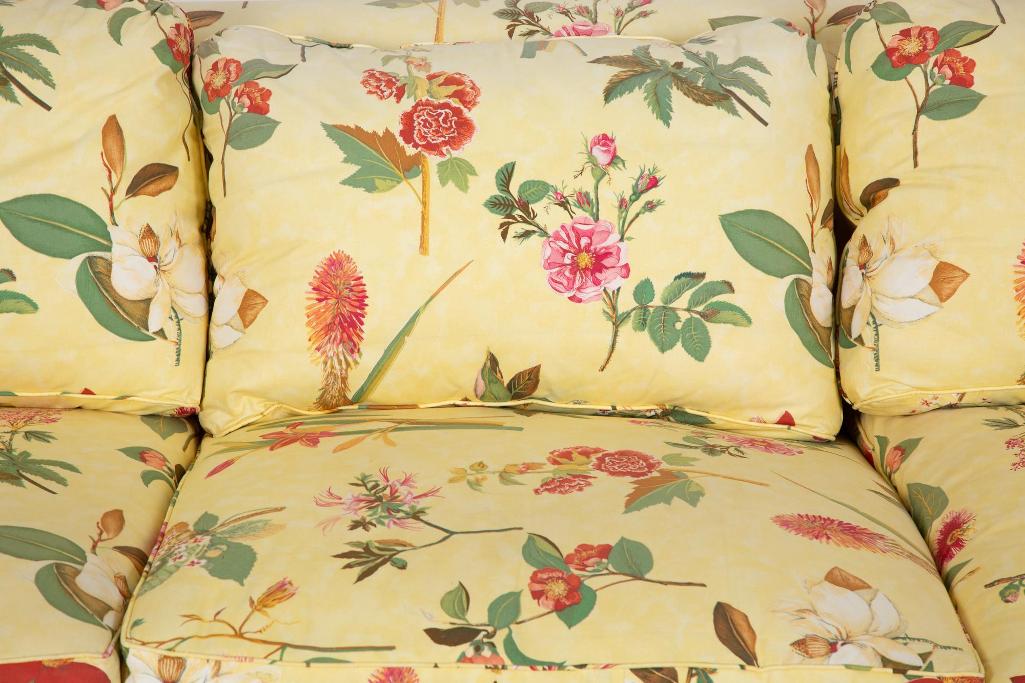 A Yellow Floral Chintz Upholstered Sofa and a Pair of Matching Drapes