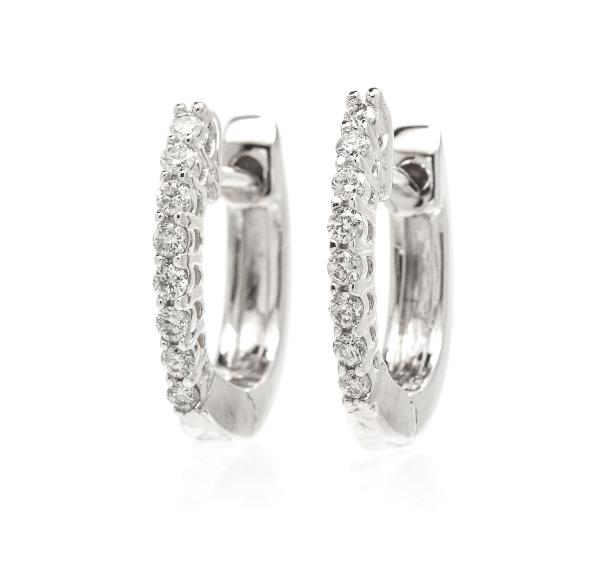 A Pair Of 14 Karat White Gold and Diamond Hoops, 1.40 dwts.