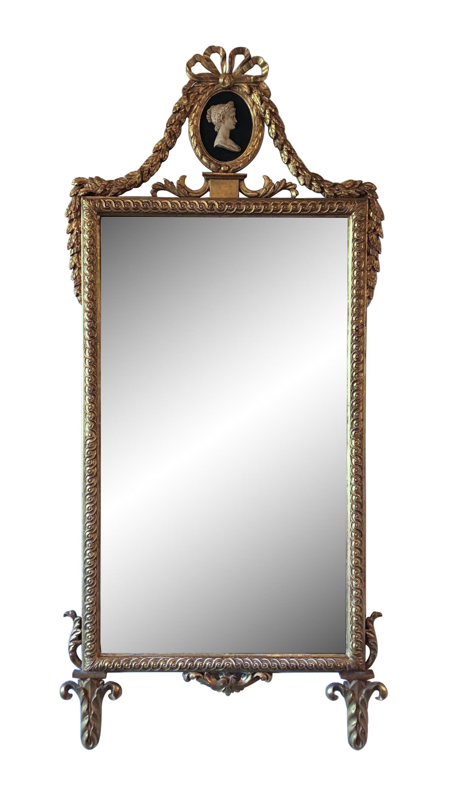 A Neoclassical Style Gilt Framed Mirror Height 54 x width 25 inches.