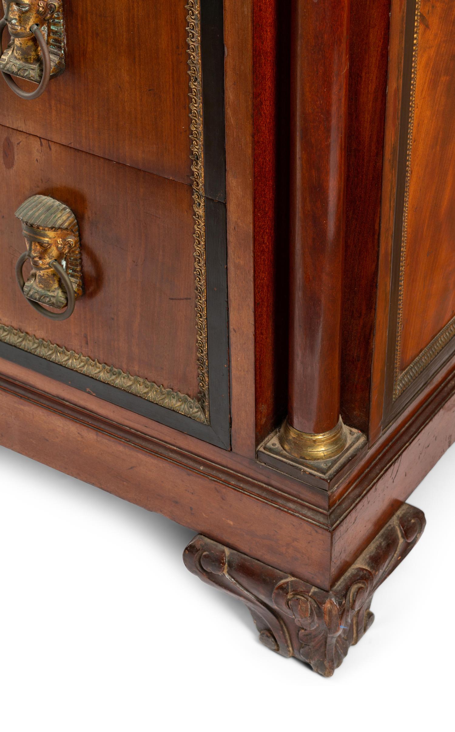 A Continental Egyptian Revival Gilt Metal Mounted Walnut Marble-Top Commode
