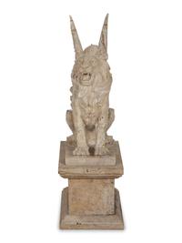 A Carved Marble Winged Seated Lion on Pedestal Base