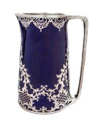 A Large Porcelain Silver Overlay Water Pitcher Height 10 1/2 inches.