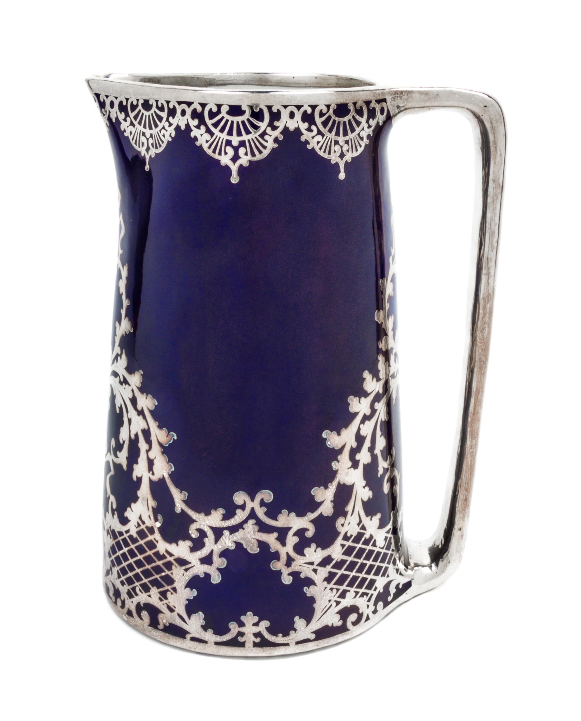 A Large Porcelain Silver Overlay Water Pitcher Height 10 1/2 inches.