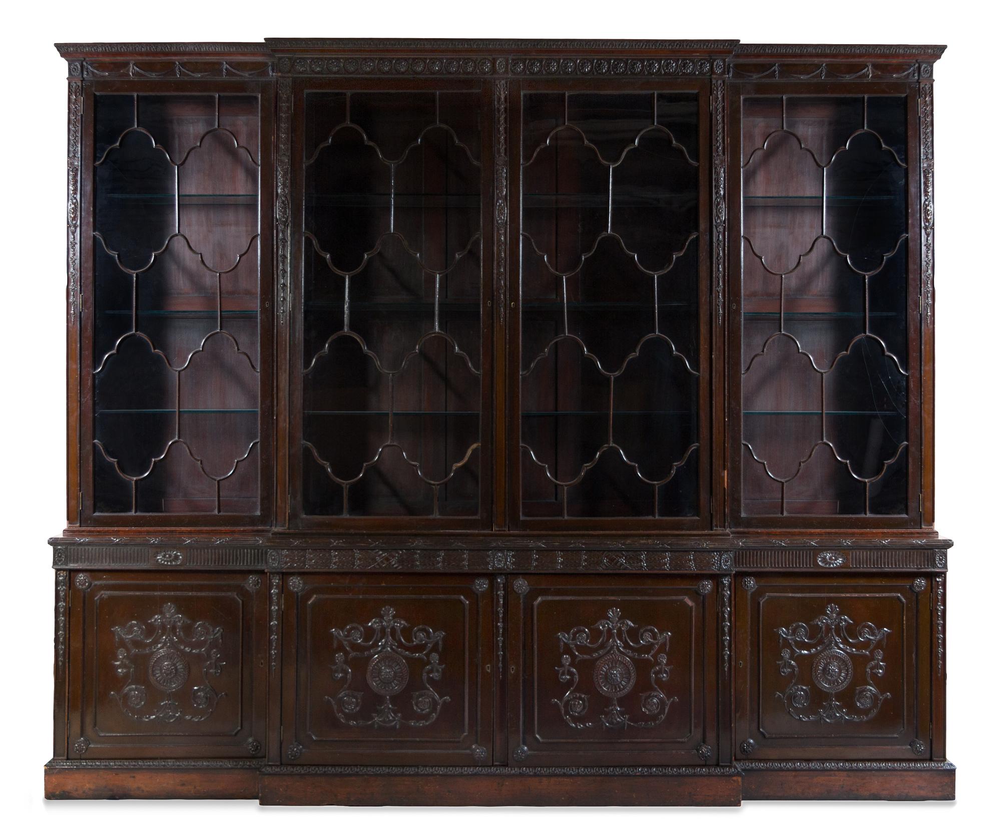 A Regency Carved Mahogany Breakfront Bookcase Height 110 x width 132 x depth 21 inches. — 19TH CENTURY