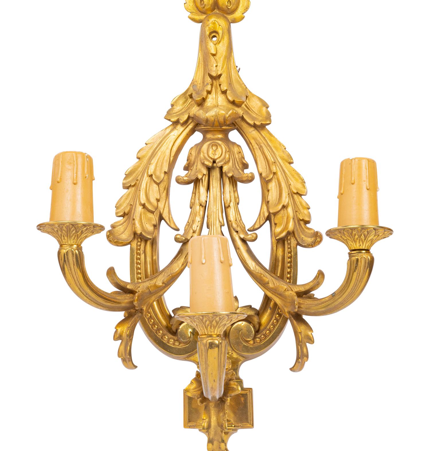 A Set of Four Louis XVI Style Gilt Metal Three-Light Sconces