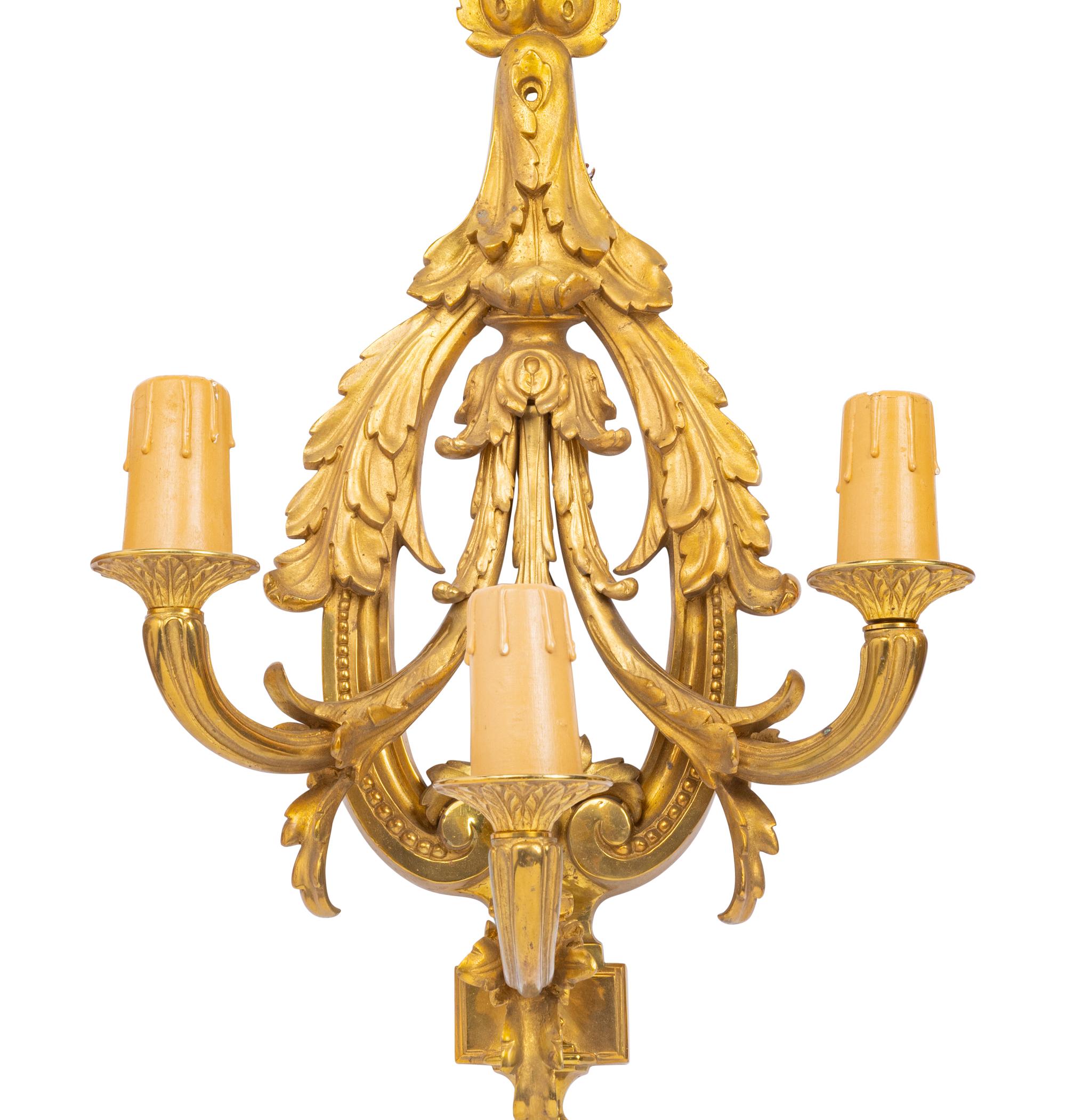 A Set of Four Louis XVI Style Gilt Metal Three-Light Sconces