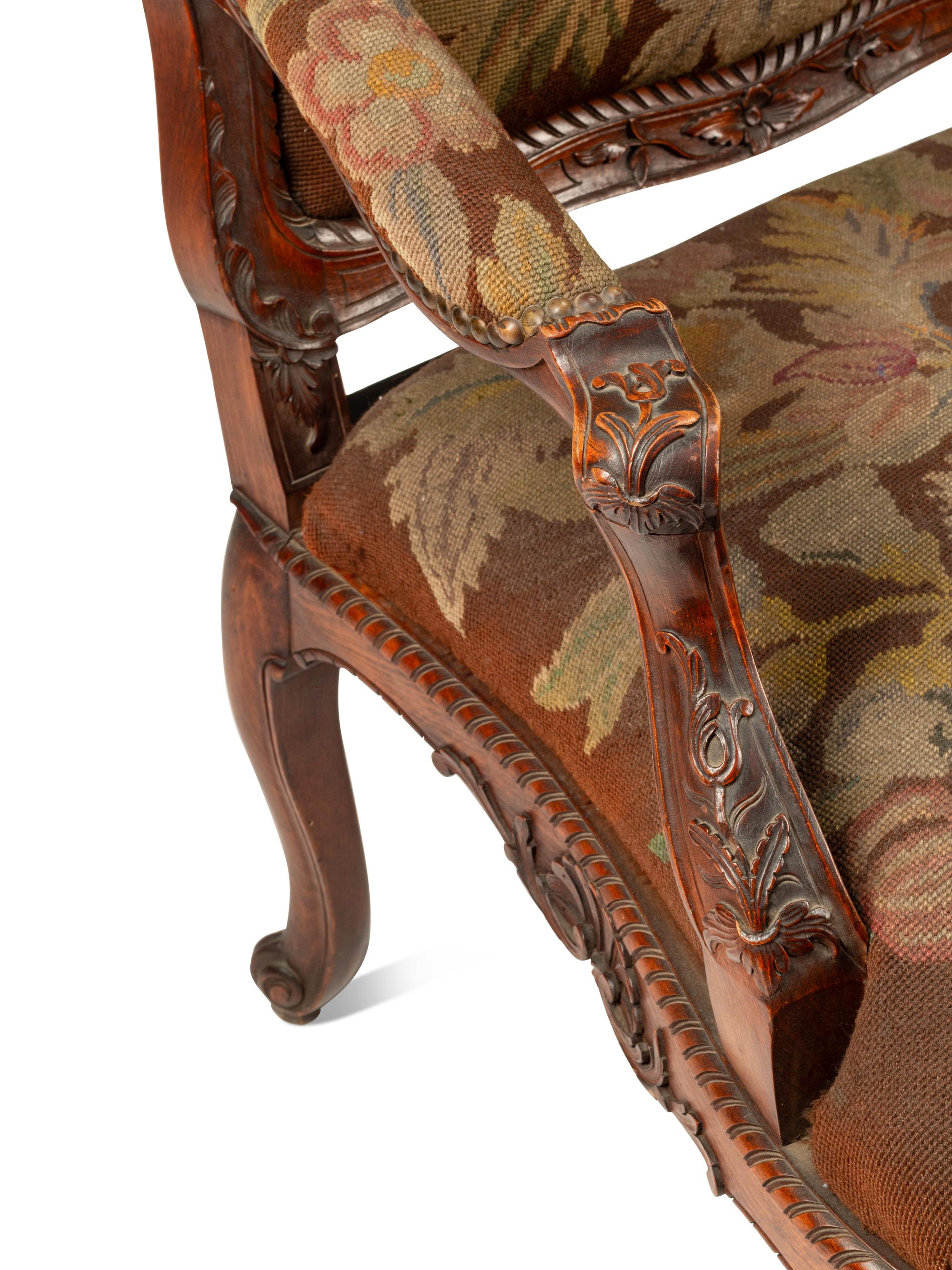 A Pair of Régence Style Carved Walnut Fauteuils