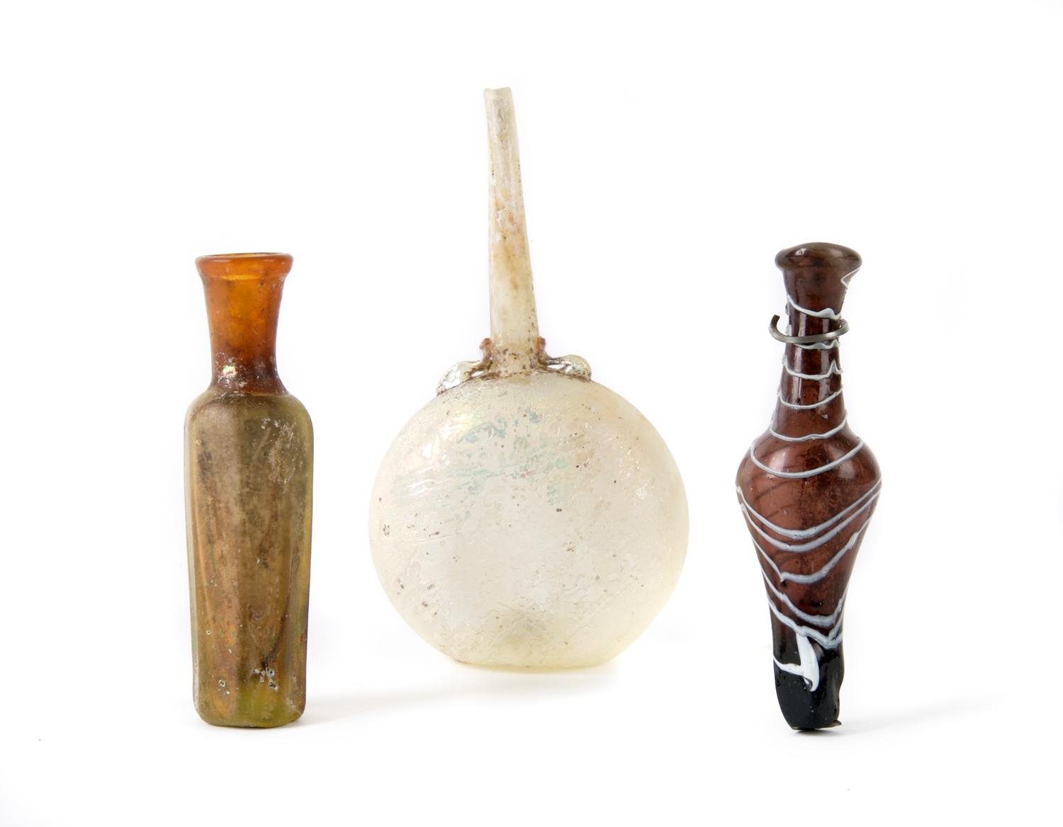 A Group of Three Islamic Glass Vessels, Height of tallest 5 1/2 inches.