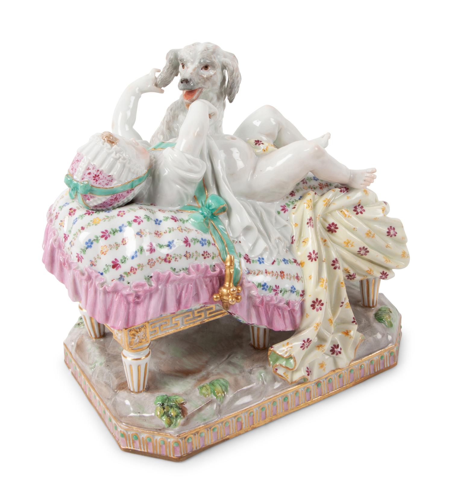 A Meissen Porcelain Figural Group of a Child in Bed with Dog