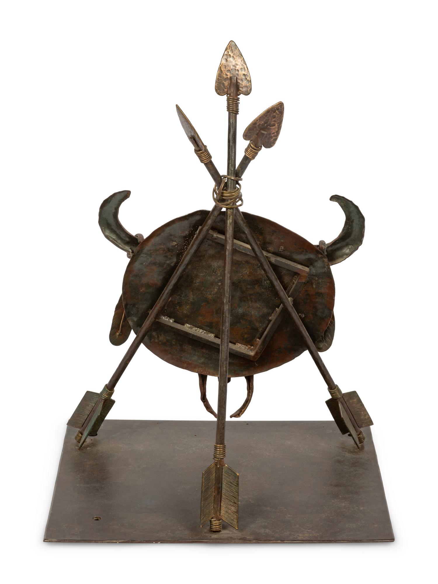 A Bronze Sculpture of a Buffalo Skull Mounted on a Shield and Arrows