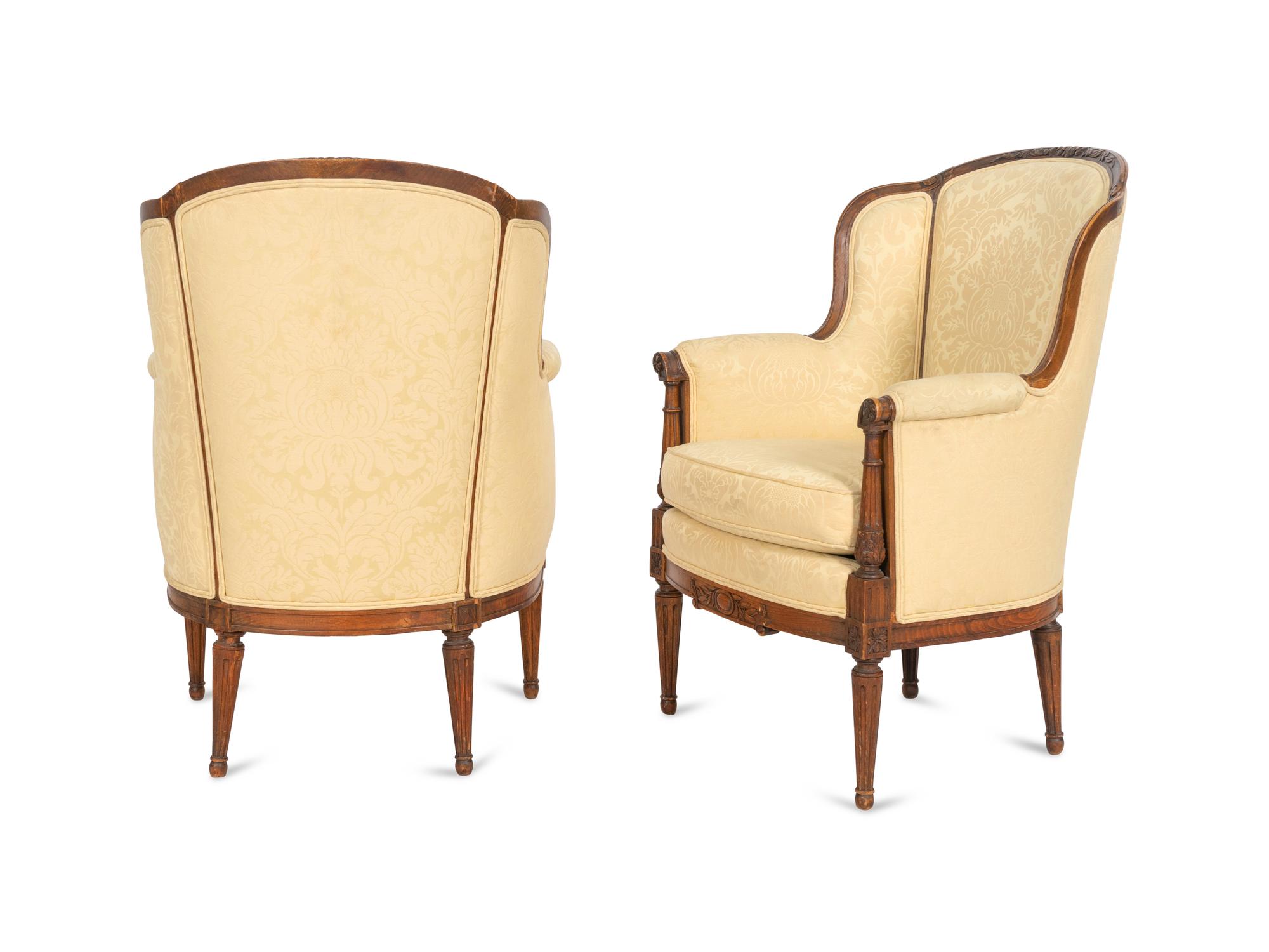 A Pair of Louis XVI Style Carved Walnut Bergères