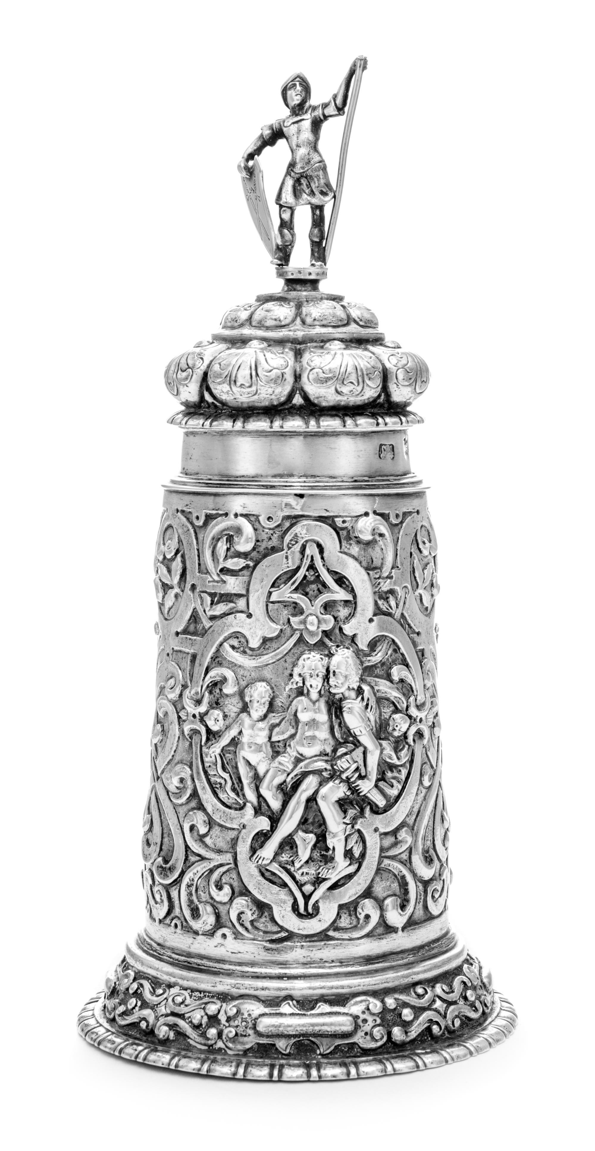 An Estonian Silver Tankard, Maker's Mark ET, Tallinn, Late 19th Century, having a domed cover surmounted by a figural finial, the body