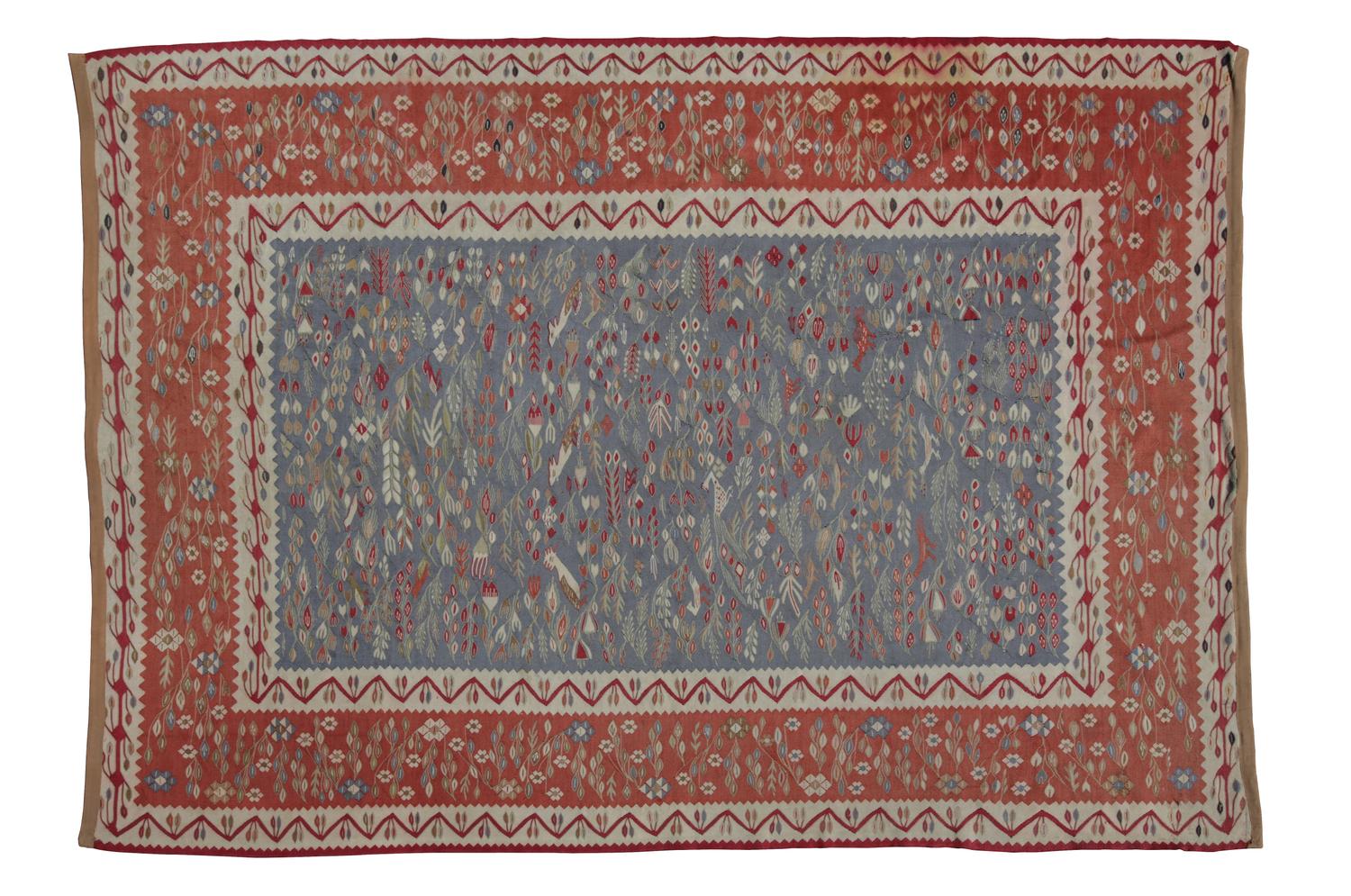 A Flat Woven Wool Rug 10 feet 7 inches x 7 feet 6 inches.