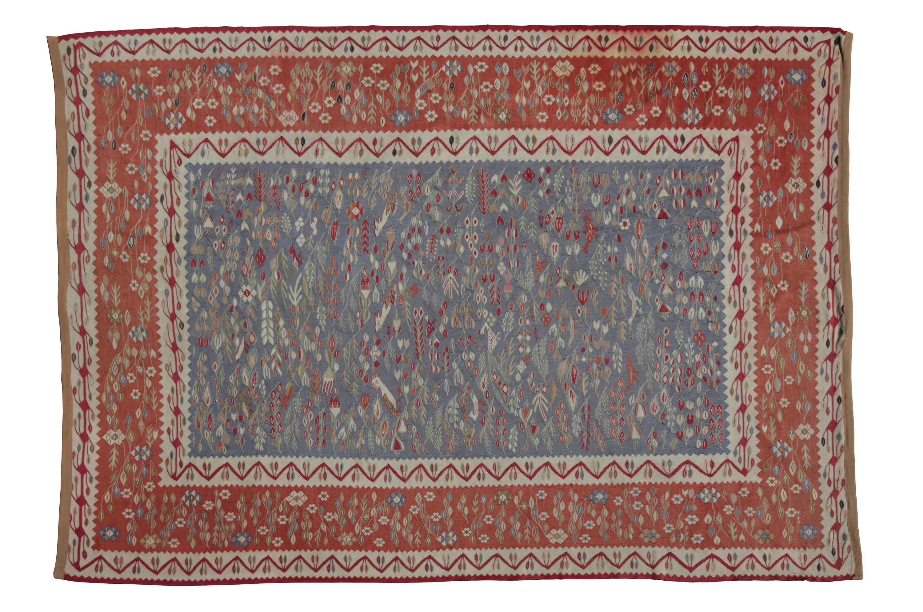A Flat Woven Wool Rug 10 feet 7 inches x 7 feet 6 inches.