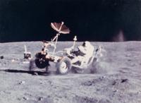 YOUNG, John Watts (1930-2018). Photograph of Young driving a moon buggy, signed (“John Young”) to Ambassador Edward Joseph Perkins.