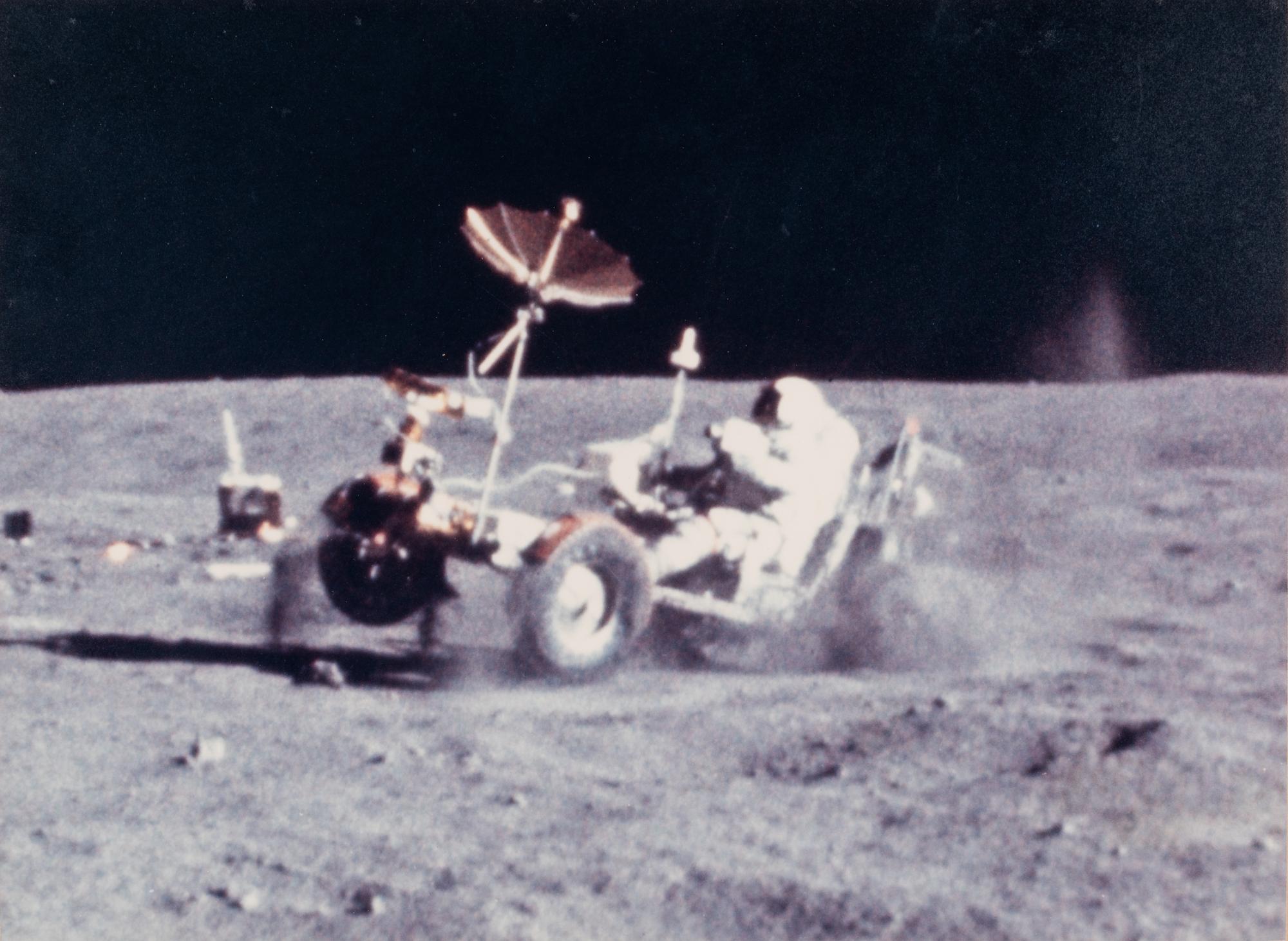 YOUNG, John Watts (1930-2018). Photograph of Young driving a moon buggy, signed (“John Young”) to Ambassador Edward Joseph Perkins.