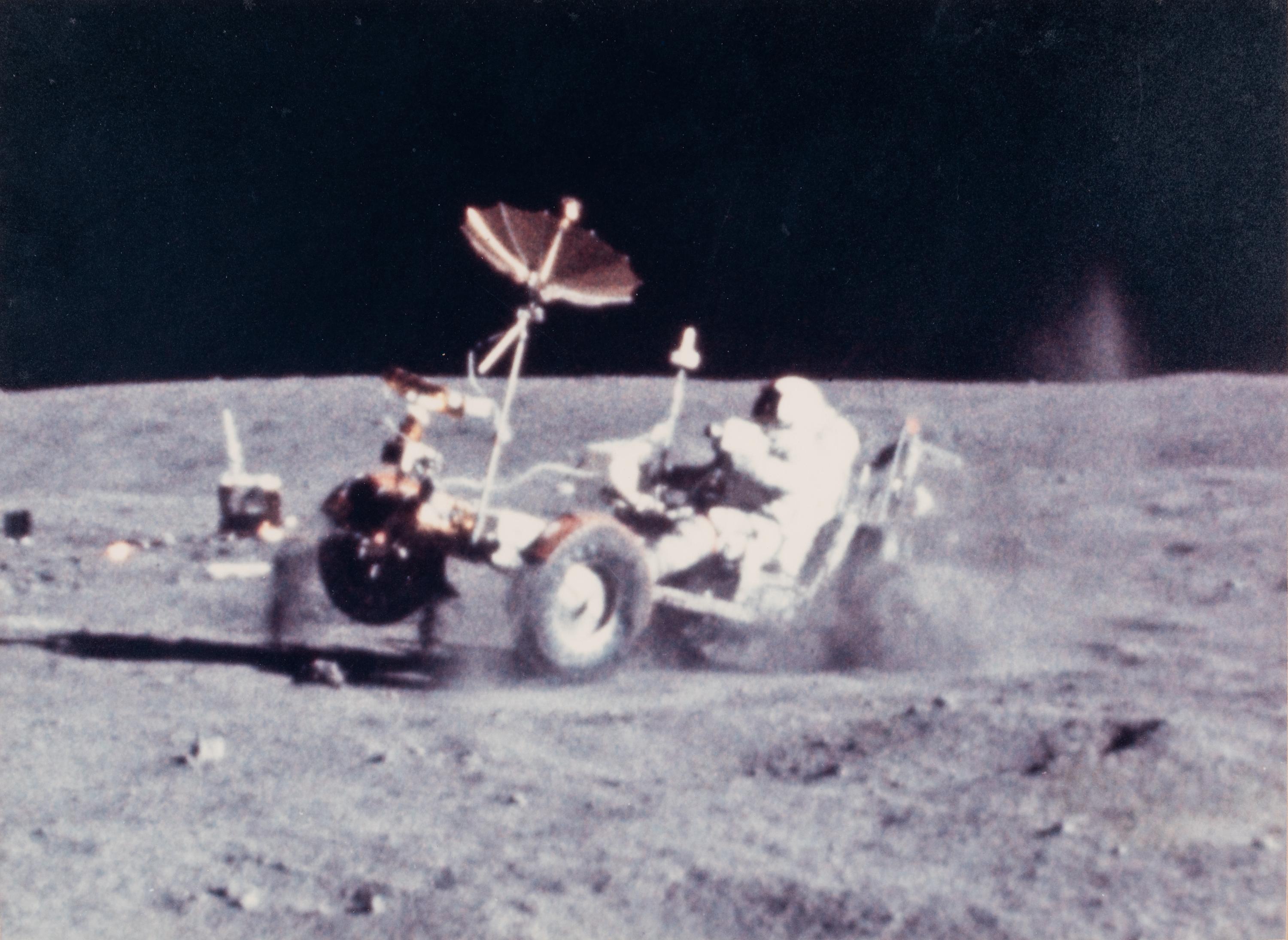 YOUNG, John Watts (1930-2018). Photograph of Young driving a moon buggy, signed (“John Young”) to Ambassador Edward Joseph Perkins.