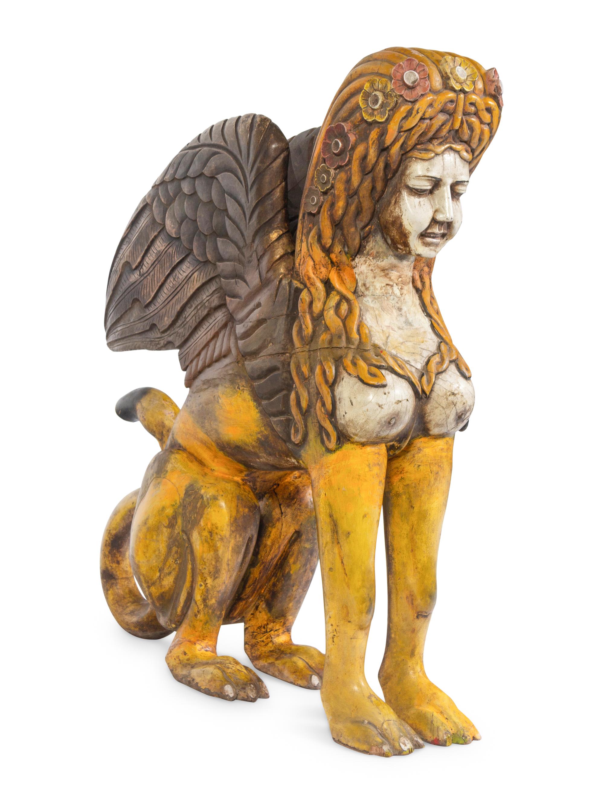 A Large Carved and Polychrome Decorated Wood Sphinx