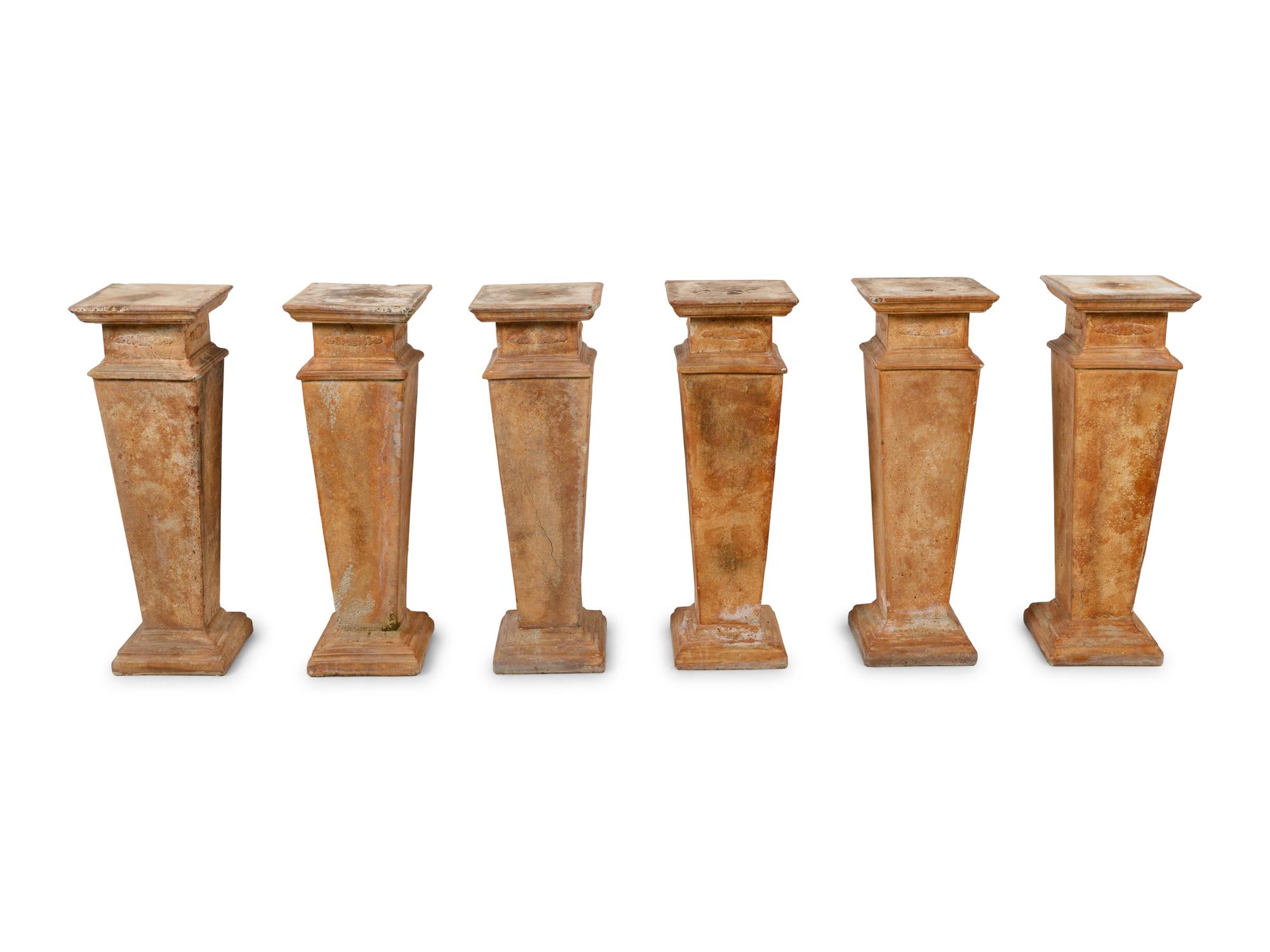 A Group of Six Cast Stone Pedestals