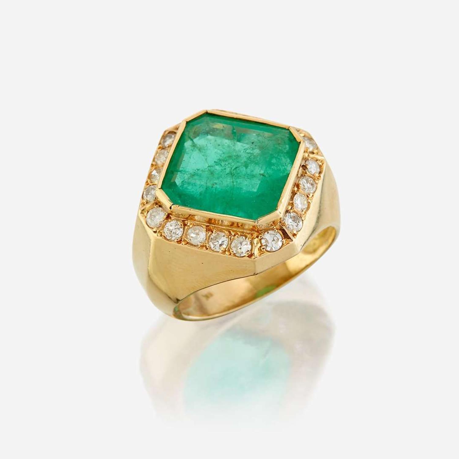 An emerald, diamond, and eighteen karat gold ring