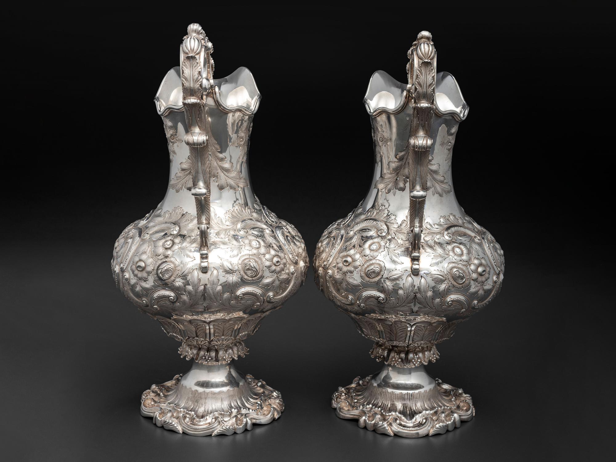 A Pair of American Repousse Silver Presentation Pitchers