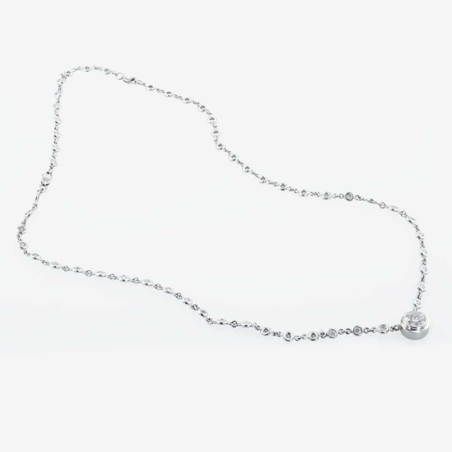 A 14K, white gold diamond bezel set necklace