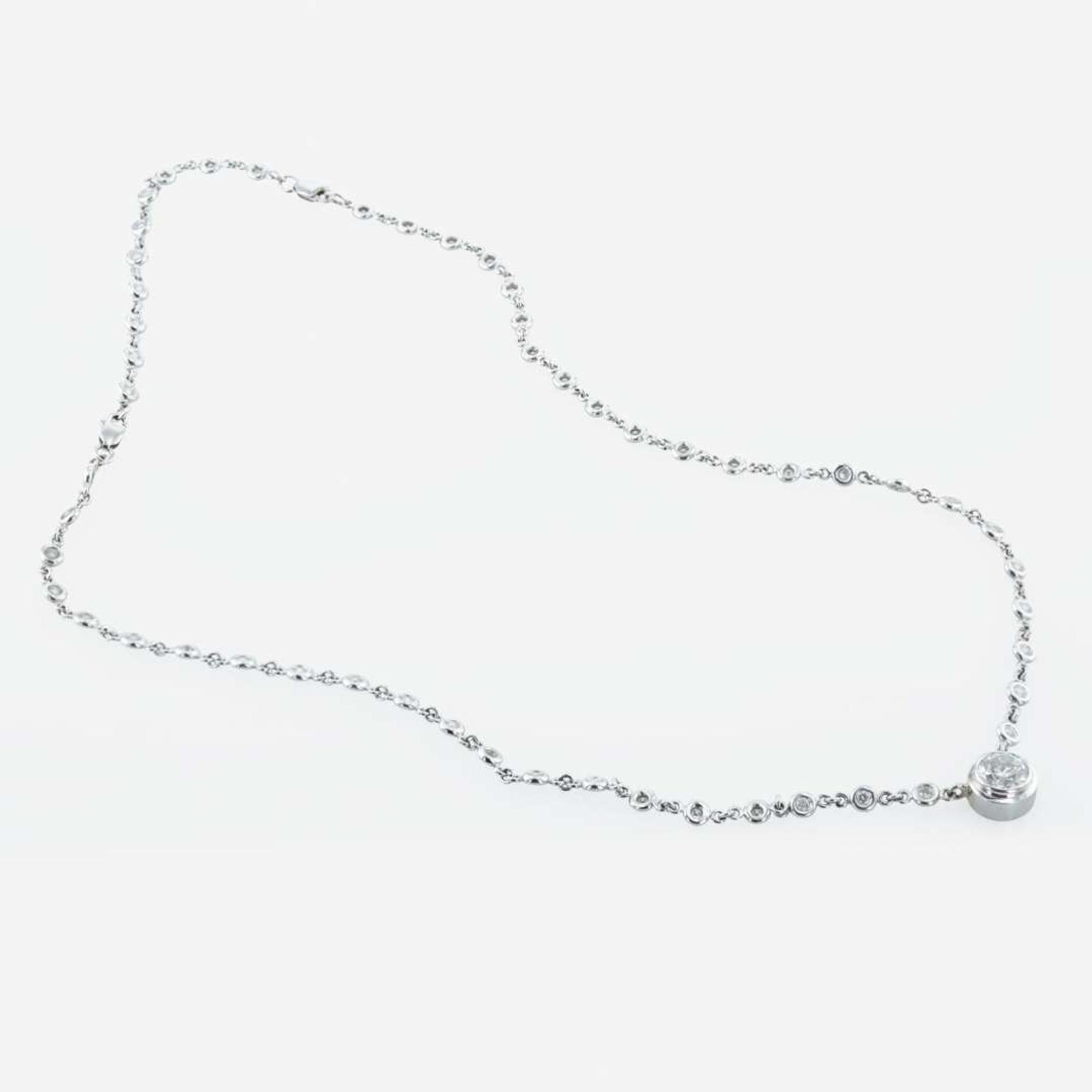 A 14K, white gold diamond bezel set necklace