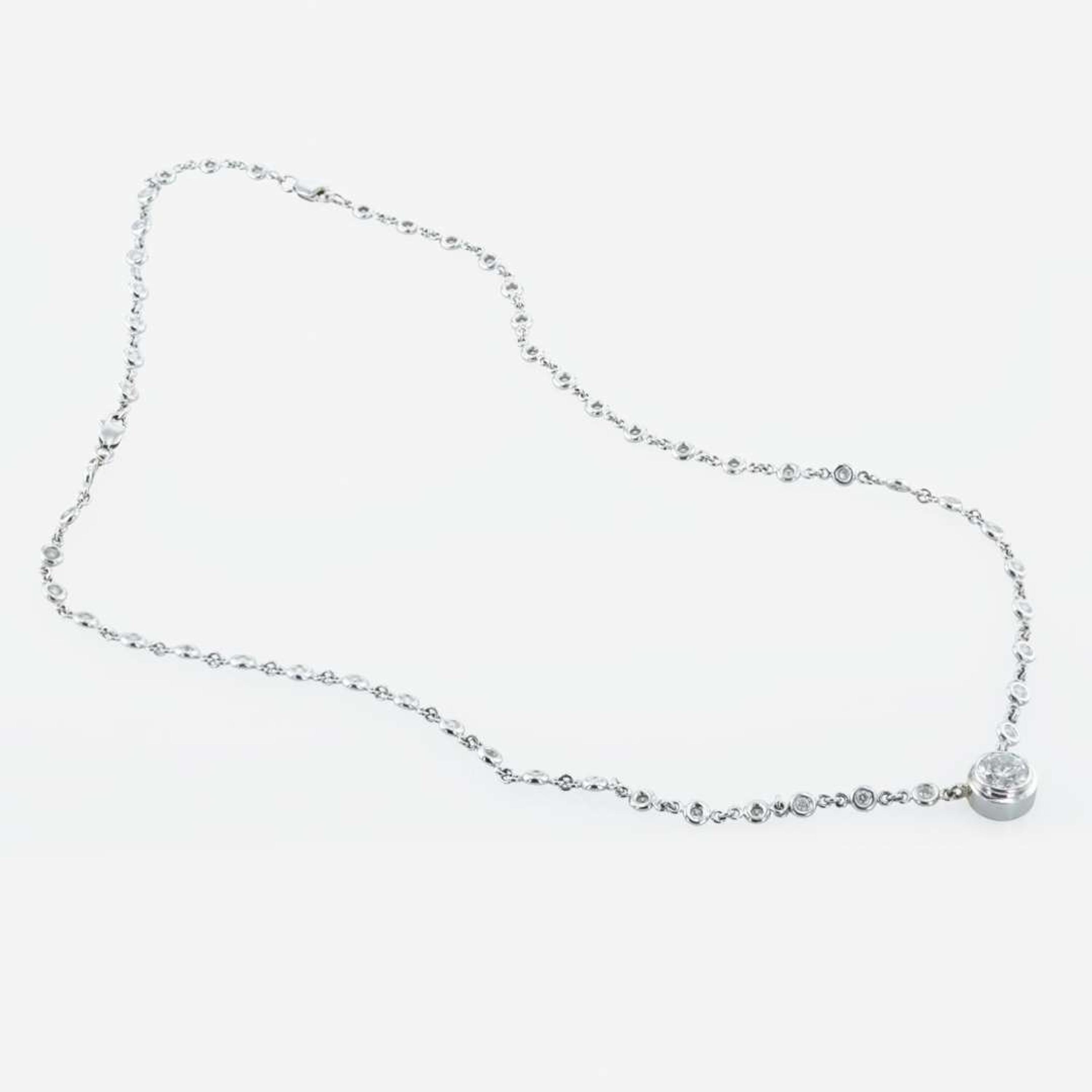 A 14K, white gold diamond bezel set necklace