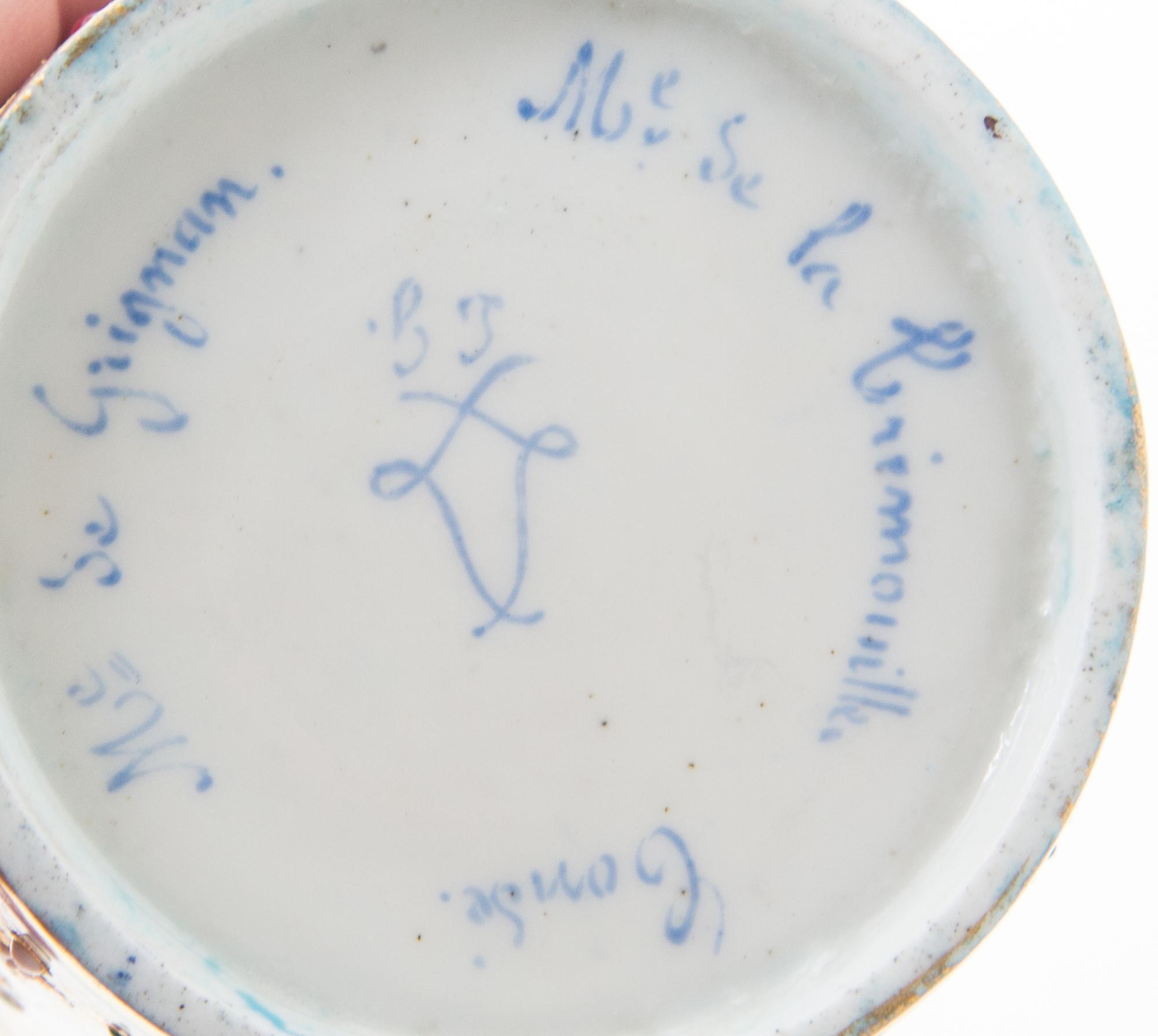 A Sevres Jeweled Porcelain Cup Height of cup 2 7/8 inches, diameter of saucer 5 1/8 inches.