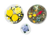 Rick Ayotte, (American), three glass paperweights, each of floral decoration, one including a Summer Tager with ladybug in a garden