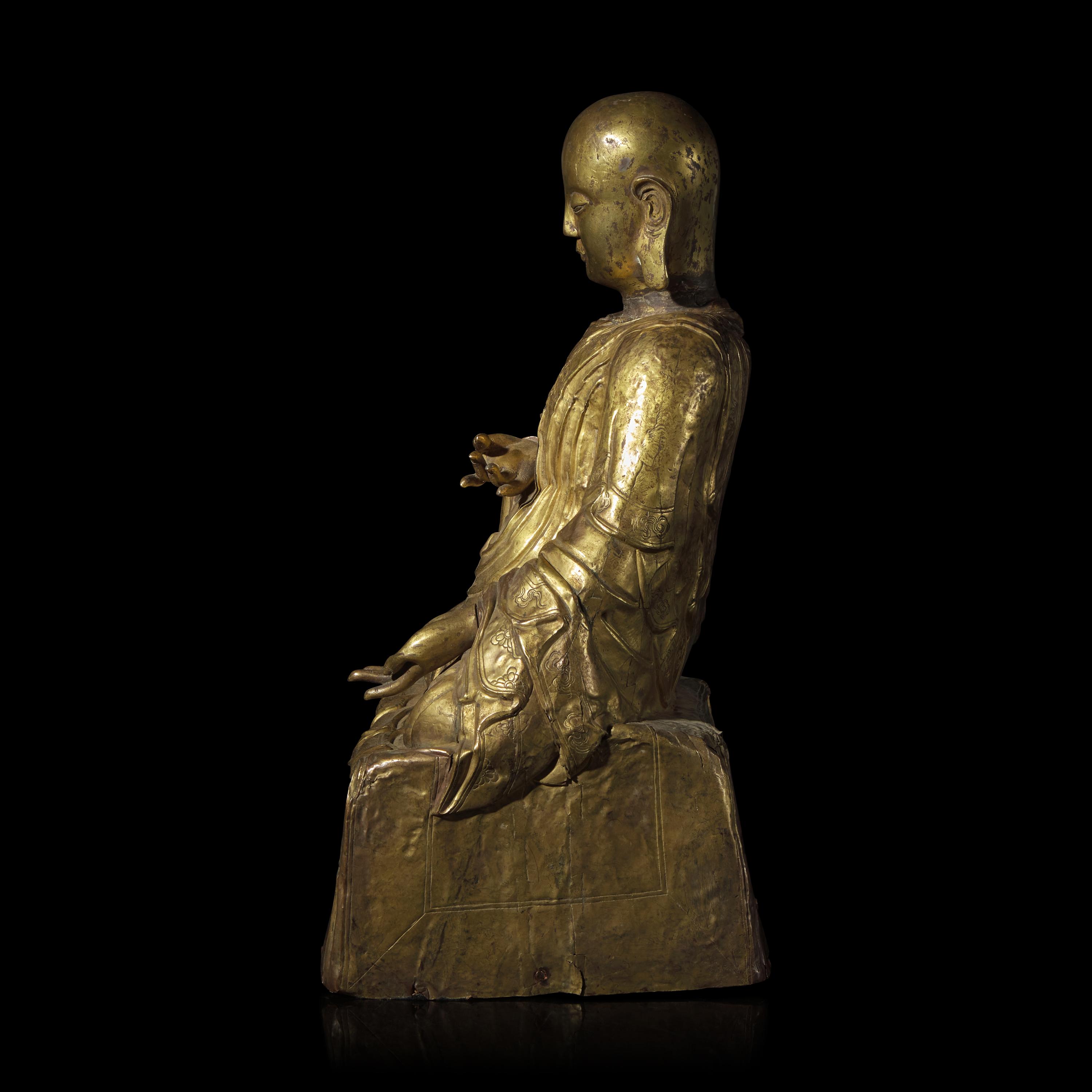 A Mongolian Gilt Copper Repoussé Figure of a Seated Luohan or Monk, 19th Century 清晚期 蒙古銅錘揲羅漢像