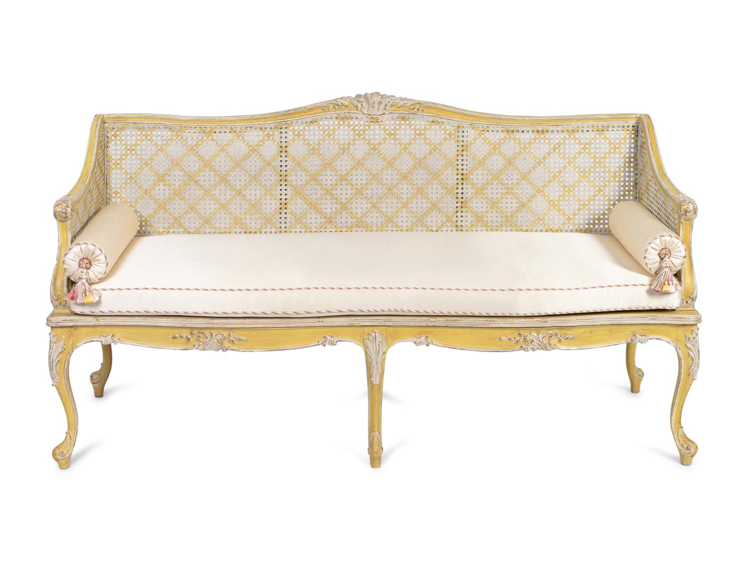 A Louis XV Style Caned and Cream-Painted Settee