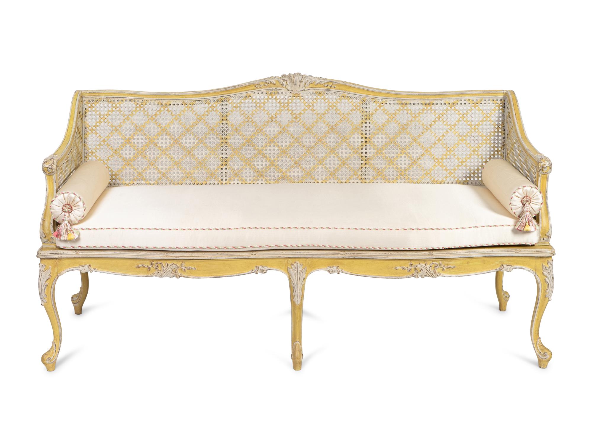 A Louis XV Style Caned and Cream-Painted Settee
