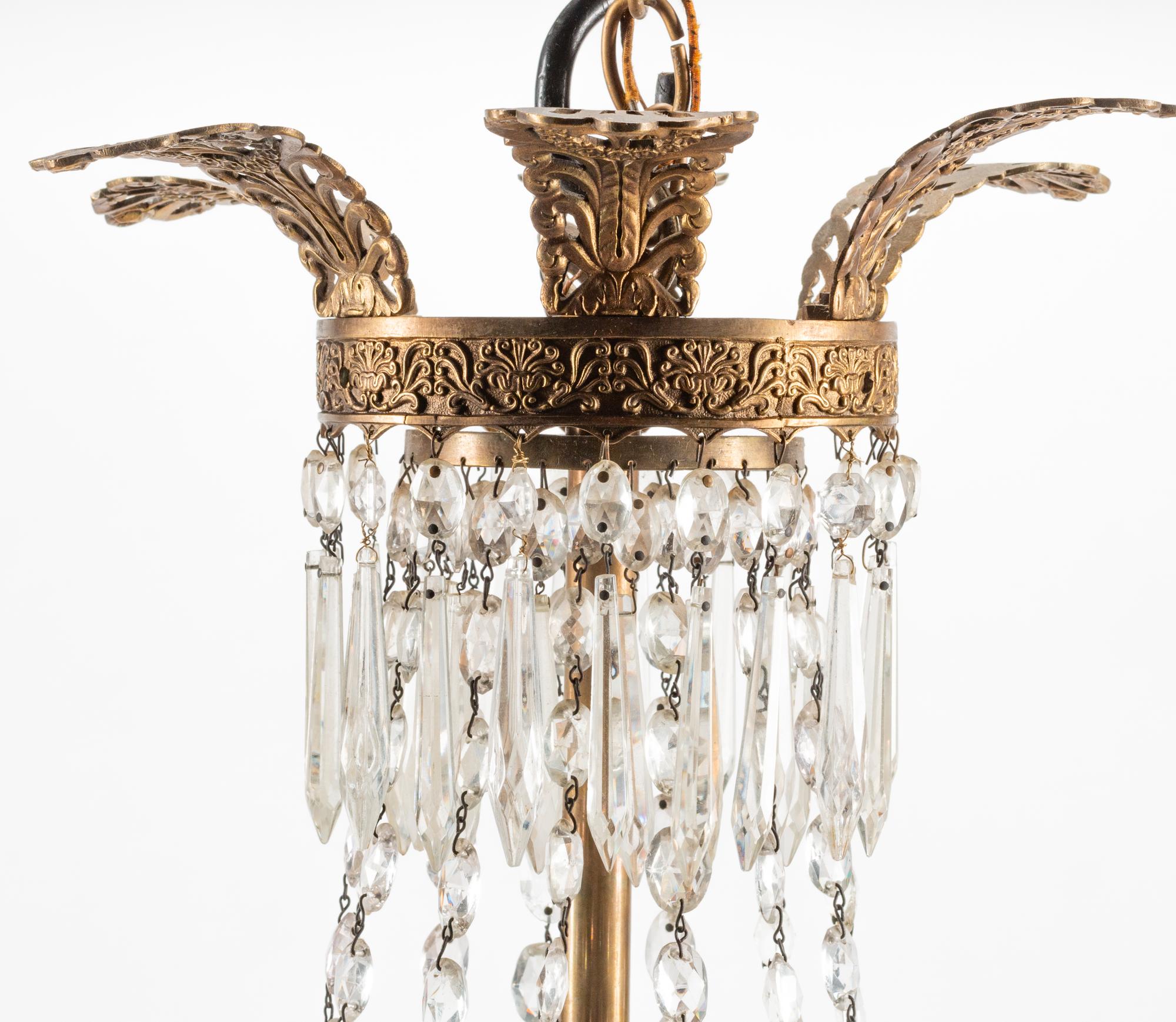 An Empire Style Bronze and Glass Twelve-Light Chandelier