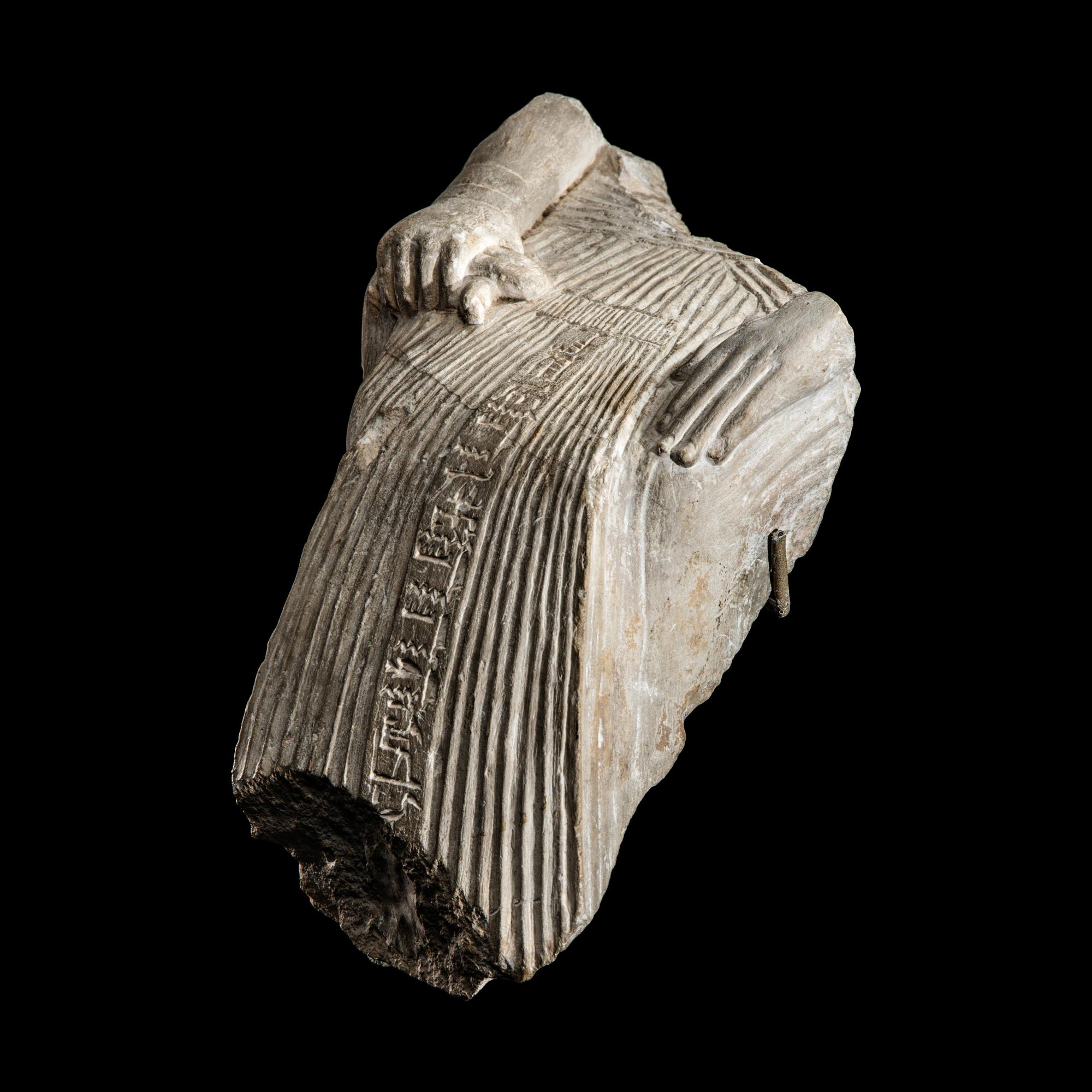 An Egyptian Limestone Fragment of a Seated Scribe