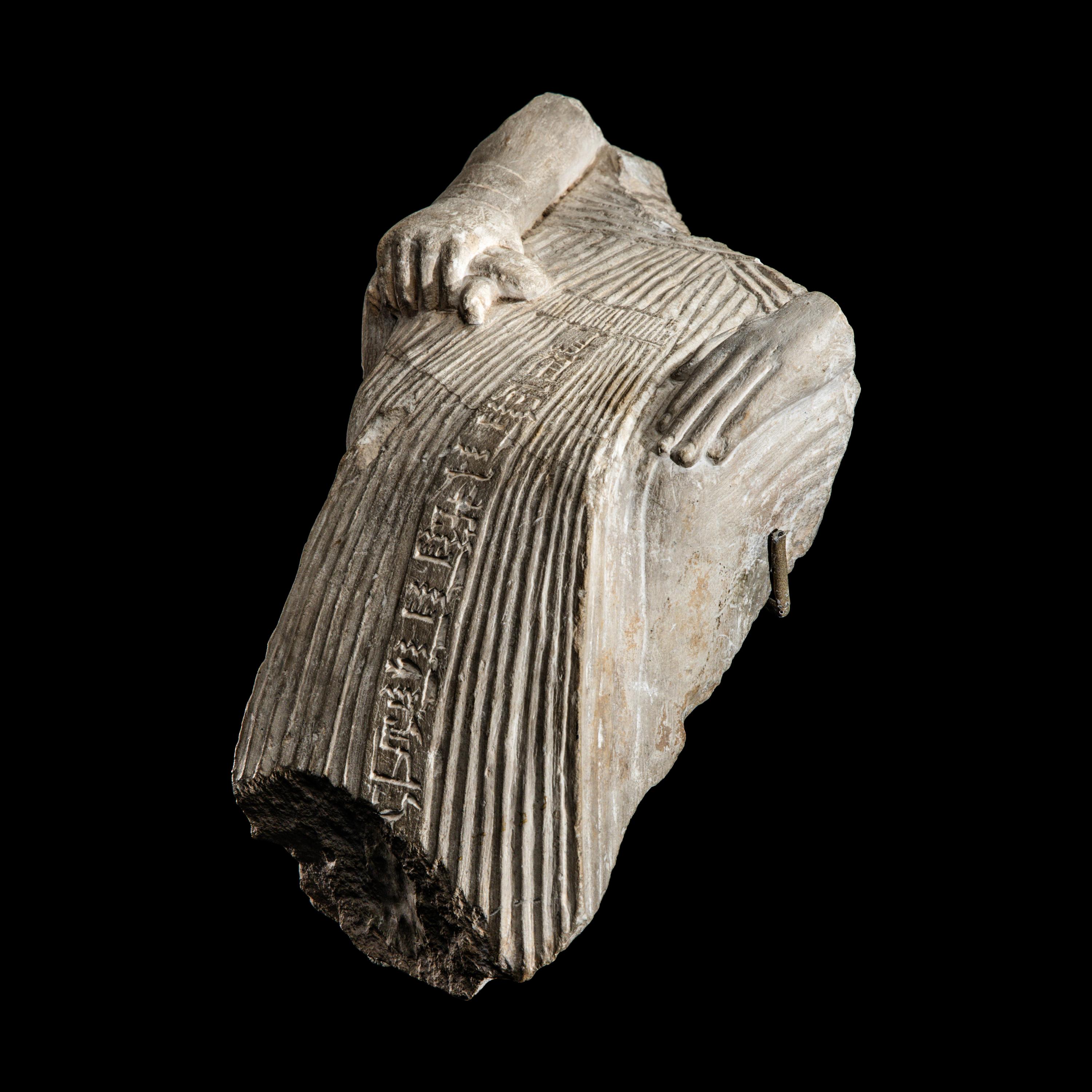 An Egyptian Limestone Fragment of a Seated Scribe