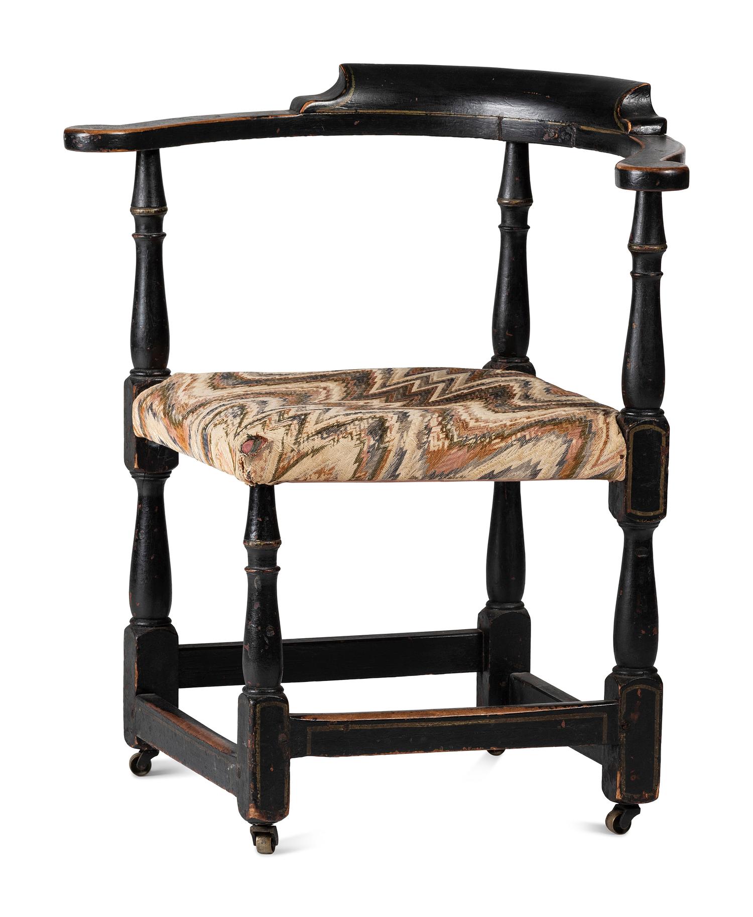 A William and Mary Black Painted and Parcel Gilt Roundabout Corner Chair